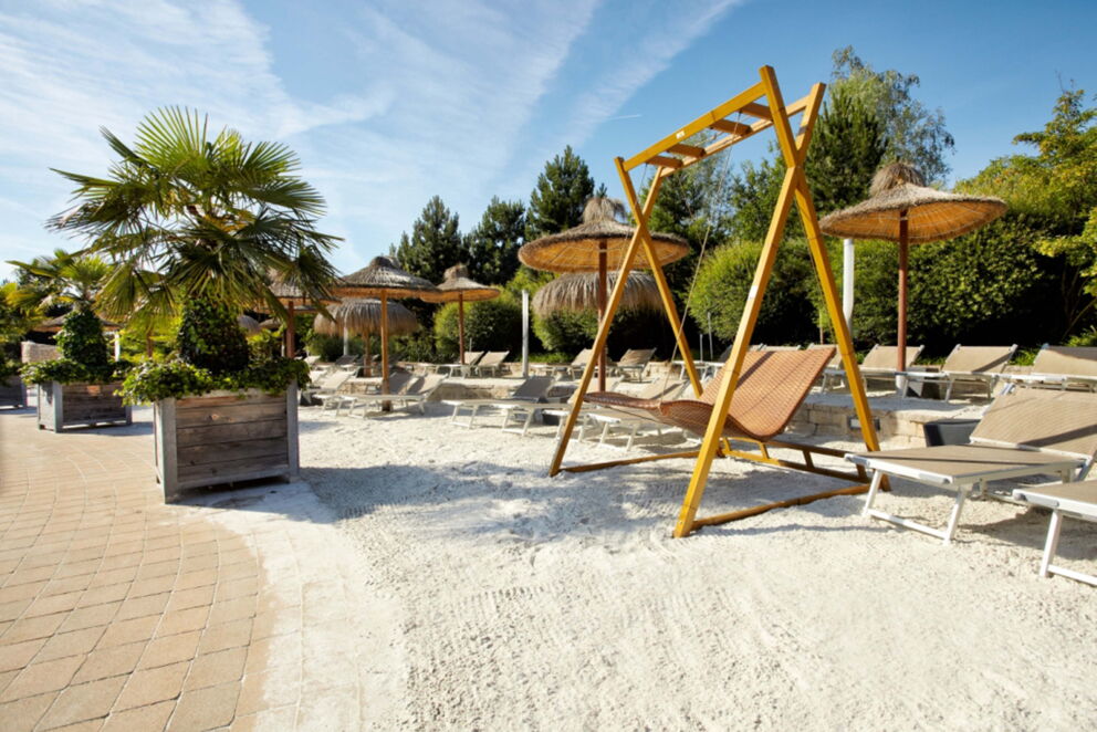 The beach at Therme Geinberg with Hollywood swing and sun loungers