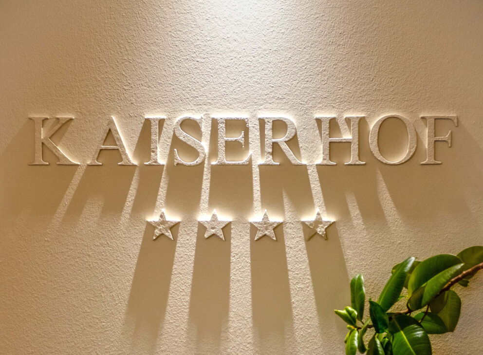 Sign with the inscription Der Kaiserhof with the four stars on the wall